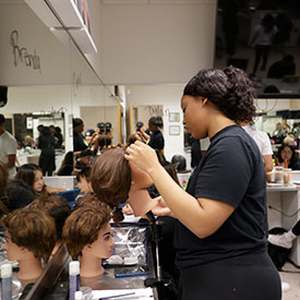 Tricoci student learning on mannequin